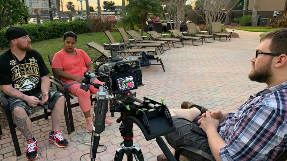 A photo of me interviewing two of the subjects of the documentary 'With One Step'